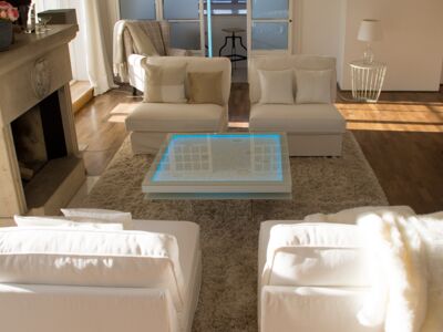 Glaszone Glass Table Shine with white enamel frame and blue RGB-lighting