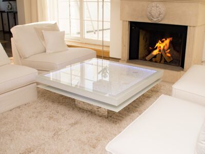 Glaszone Glass Table Shine with white enamel frame next to the fireplace